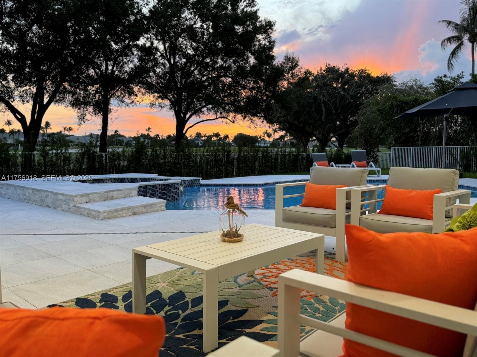 Pool and outdoor lounge at 2578 NW 63rd Ln at sunset